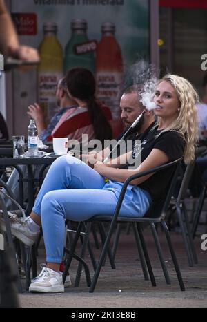 Bihac, Bosnia and Herzegovina - Sep 06, 2023: A walking in the center of Bihac city in Bosnia and Herzegovina federation in a sunny summer evening. Se Stock Photo