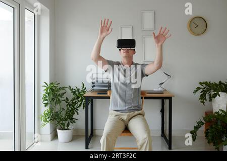 Software developer testing new virtual reality app he created Stock Photo
