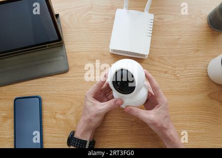 Hands of man installing survillance camera in home office Stock Photo