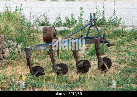 Blue metal plow used for plowing fields. Stock Photo