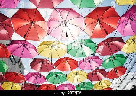 Hanging colorful umbrellas against the sky. Stock Photo