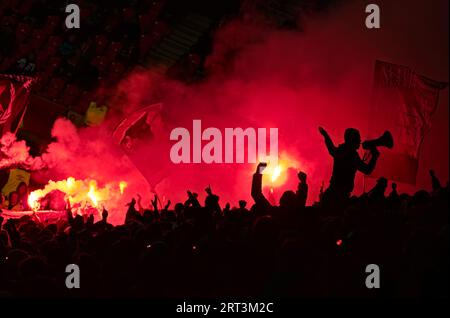 Footbal soccer match Slavia Praha - Zbrojovka Brno. Slavia hooligans fans with smoke bombs and flags support their team.  Eden stadium. Stock Photo