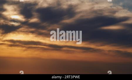 The warm glow of the setting sun illuminated the landscape, casting long shadows across as the evening descended. Stock Photo
