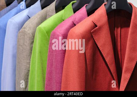 Racks with different men's suits in a men's clothing boutique. Stock Photo