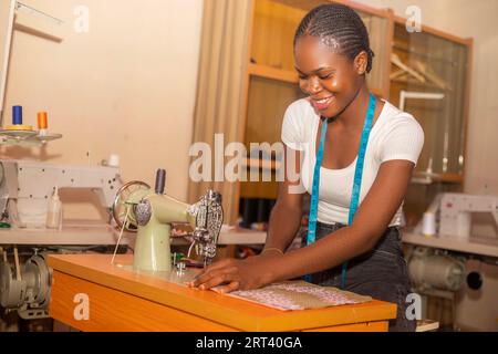 Smiling African female fashion designer working in her studio Stock Photo
