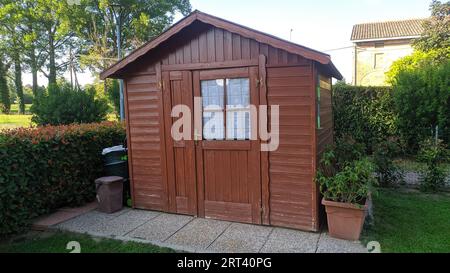 Wooden house in the garden for tools Stock Photo