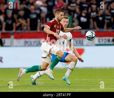 Budapest, Hungary. 31st August, 2023. Barnabas Varga of Ferencvarosi TC  competes for the ball with Nassim Hnid of FK Zalgiris Vilnius during the  UEFA Europa Conference League Play Off Round Second Leg