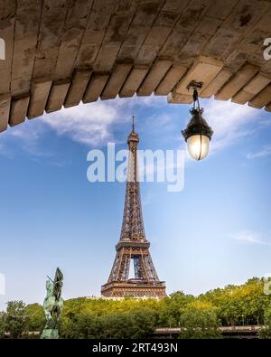 Paris, France - May 27, 2023: Eiffel tower seen from arch of Bir Hakeim bridge in Paris Stock Photo