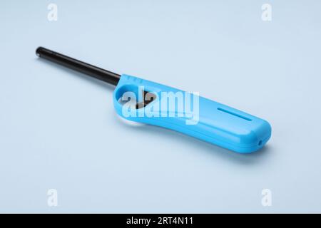 One gas lighter on light blue background Stock Photo