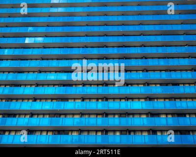 Background from the windows of a modern building. Tall building. Lots of windows. Skyscraper, floors. Human anthill. Modern hostel. Balconies Stock Photo
