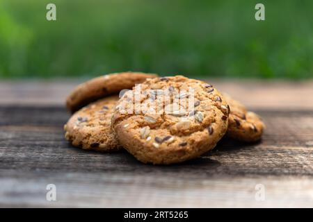 Heart shaped cookies on wooden table, sweet homemade Heart-shaped cookies with oat flakes. Oatmeal cookies with sesame seeds. oatmeal cookies with see Stock Photo