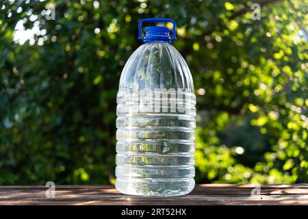 Bottle water made to plastic and green background. refreshing image and copy space. 5 liter large plastic water canister Stock Photo