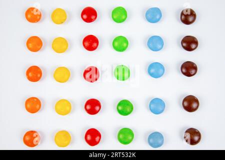 pile of colorful chocolate candies on white background, top view Stock Photo