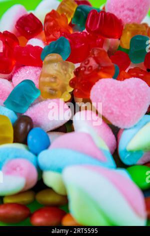 piles of various kinds of sweets and candies. Milk chocolate candy and jelly gum. Stock Photo