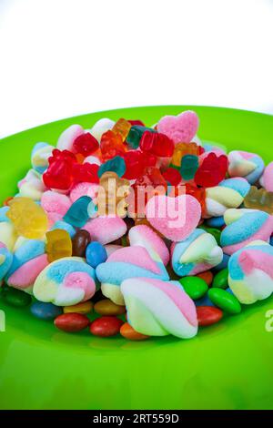 piles of various kinds of sweets and candies. Milk chocolate candy and jelly gum. Stock Photo