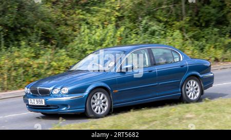 Milton Keynes,UK-Sept 10th 2023: 2002 blue Jaguar X type car travelling on an English road. Stock Photo