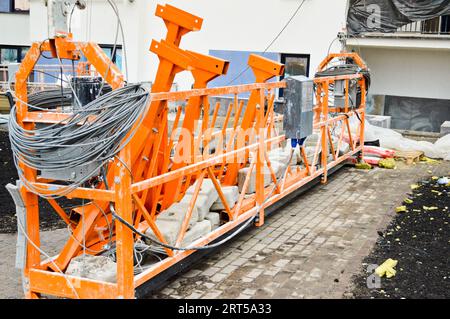 Large iron metal building facade elevator cradle for lifting workers and a load of building materials during the repair of the external facade and pai Stock Photo