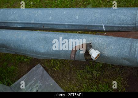 Iron metal tin rusty old industrial pipe with tap drain valve with valve. Stock Photo