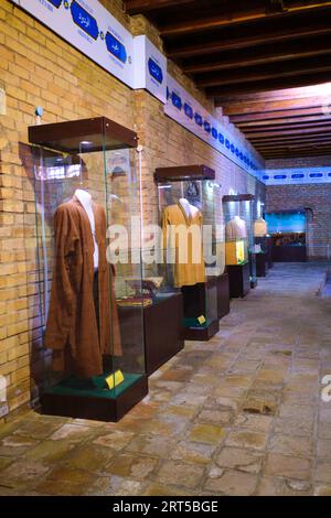 A display of traditional wardrobe, men's robes, kaftans. At the Underground mosque in Turkestan, Kazakhstan. Stock Photo