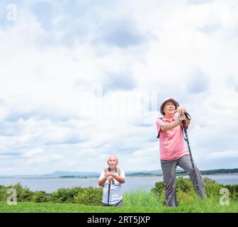 Happy Senior couple hiking together on the mountain and coast Stock Photo