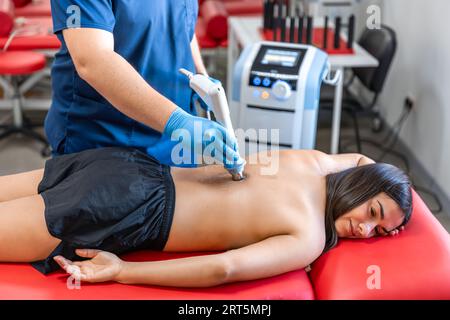 Extracorporeal shockwave therapy, physical therapy for neck and back muscles. Stock Photo