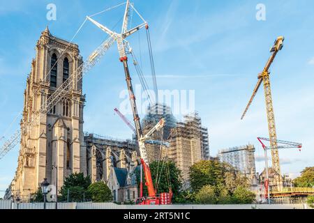 The side of Notre-Dame Cathedral, under reconstruction, with cranes in the background after the fire in 2019, Paris France Stock Photo