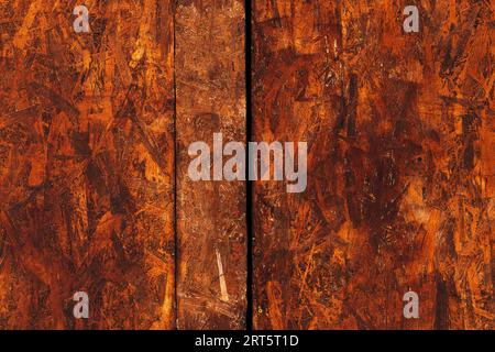 Oriented strand board (OSB) surface as background, brown painted wood Stock Photo