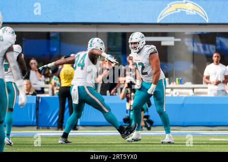 Miami Dolphins offensive tackle Vernon Carey (72), linebacker Donnie  Spragan (59) and safety Jason Allen celebrate after Allen's interception on  a pass thrown by Chicago Bears quarterback Rex Grossman during the third