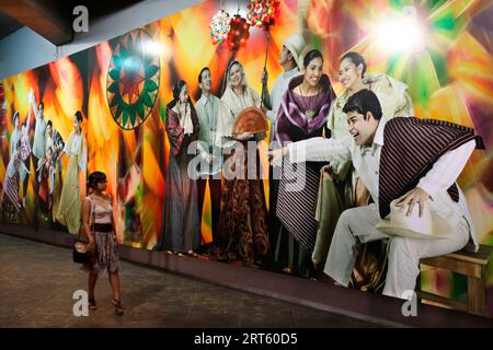 Young woman looking at a wail painting in a tunnel, Makati. Stock Photo