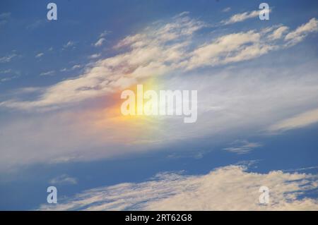 Sundog or parhelion - a mini rainbow when cold weather brings ice crystals into high, cold cirrus clouds. Light is refracted. Australia, winter. Stock Photo