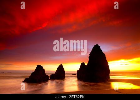 Sea Stacks silhouetted against a summer sunset at Rodeo Beach located in Northern California in the Marin Headlands. Stock Photo