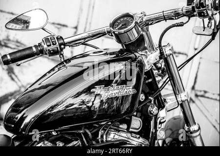 A closeup of the legendary Harley Davidson motorcycle in grayscale