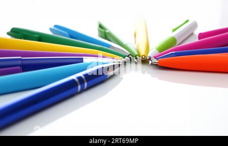 Multi colored ball pens on white background Stock Photo - Alamy