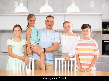 Portrait of best dad who spends his free time with cute, adorable kids in bright modern home kitchen Stock Photo