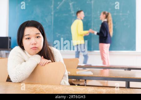 Portrait of unhappy female chinese student in auditorium Stock Photo