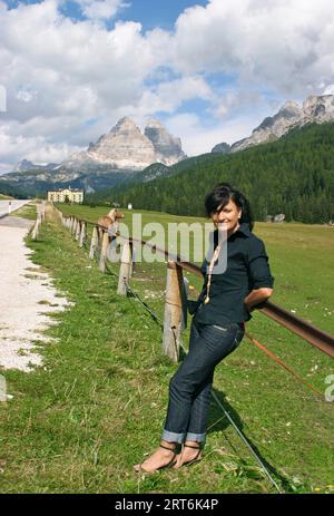 elderly woman on vacation walks on the mountain paths Stock Photo