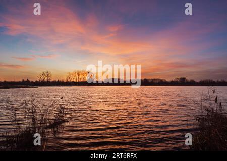 Colorful clouds after sunset over the lake, eastern Poland Stock Photo