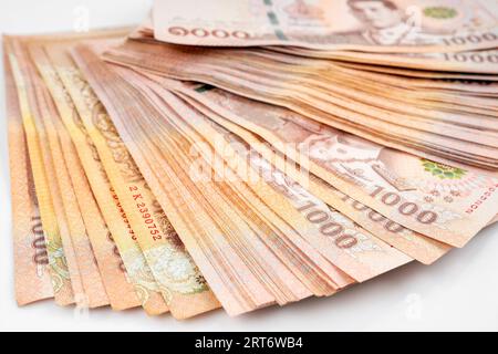 Heap of Thai 1,000 baht banknotes issued by the Bank Of Thailand. Stock Photo