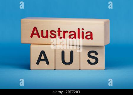 Australia and AUS symbol. Concept words Australia and AUS on wooden blocks.  English name and abbreviation of country name. Copy space.3D rendering on Stock Photo