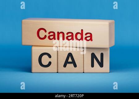 Canada and CAN symbol. Concept words Canada and CAN on wooden blocks.  English name and abbreviation of country name. Copy space.3D rendering on blue Stock Photo