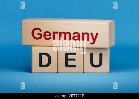 Germany and DEU symbol. Concept words Germany and DEU on wooden blocks.  English name and abbreviation of country name. Copy space.3D rendering on blu Stock Photo