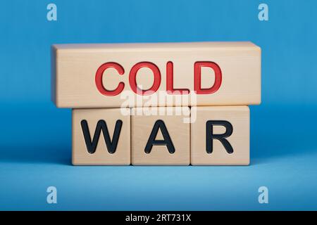Cold war word cloud concept. Collage made of words about cold war. Copy space.3D rendering on blue background. Wooden cube blocks. Stock Photo