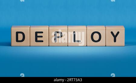 Deploy word on wooden cubes.3D rendering on blue background. Stock Photo