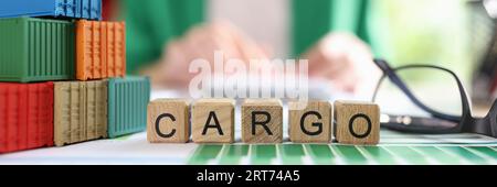 Heap of various shipping containers and word cargo collected from wooden cubes in financial report. Stock Photo
