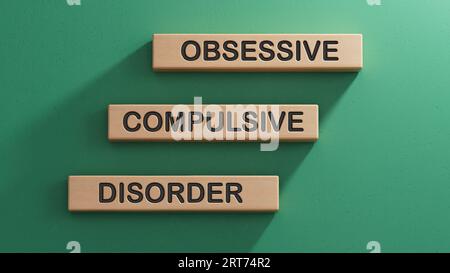 Obsessive Compulsive Disorder words on wooden blocks. Psychiatry psychological problem concept, OCD.3D rendering on green background. Stock Photo