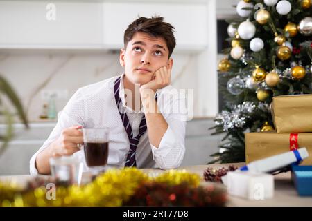 man suffering while hungover after new year party Stock Photo