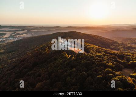 Aerial photo by drone of The Barrow (cairn) of Milan Rastislav Stefanik upon Hill with beautiful green trees around - on sunset. top view of The Barro Stock Photo