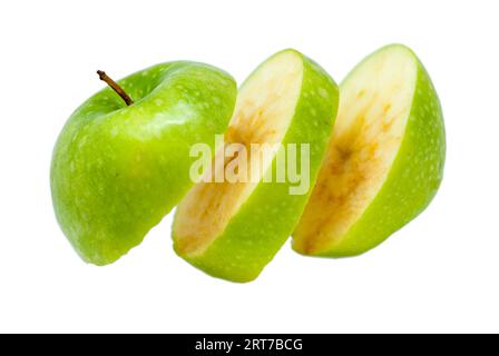 ripe delicious apple cut in slices isolated floating on white background Stock Photo