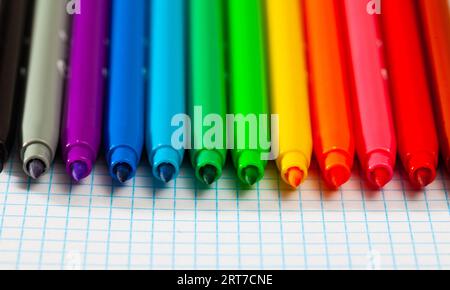 Image of opened multicolored markers on notepad Stock Photo