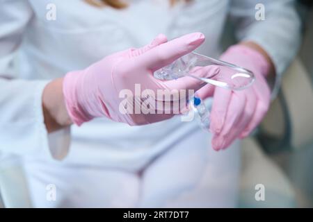 Woman doctor in protective gloves at the workplace Stock Photo